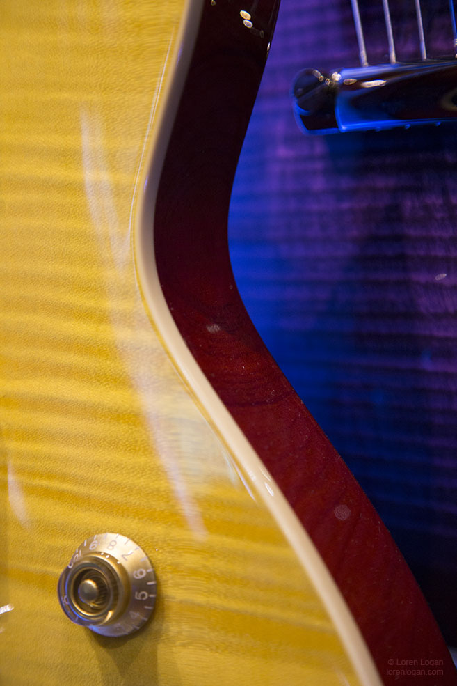 Yellow, orange, wood grains, royal purple. Colors interplay with light and shapes. And guitars.